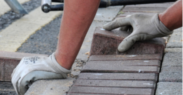 Pavers Contractor laying bricks on a commercial project.