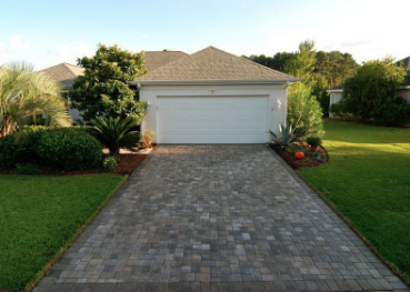 A Malabar FL home with a pave stone driveway that is part of an HOA. 