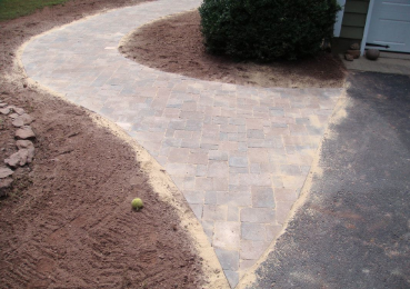 Picture of a partially completed paver walkway around side of Melbourne home.